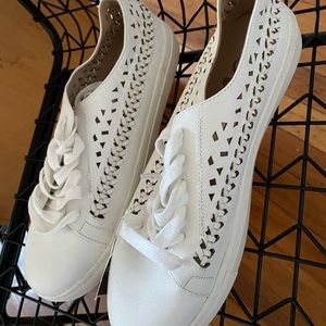 white sneakers with cutouts
